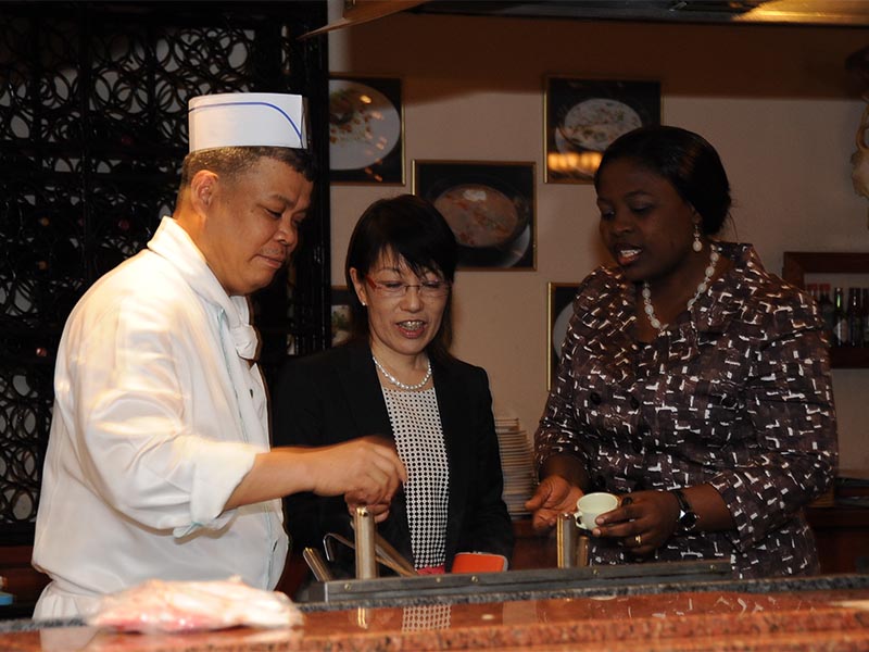 Chef Nicholas from Sheraton Abuja Hotel, Dr. Kumiko Ninomiya and Francisca Ikediashi during the preparation of Vegetable bouillon soup for Umami tasting by the participants